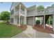 Charming two-story condo with a front porch, sidewalk, and lush green lawn at 602 Abingdon Way, Atlanta, GA 30328