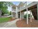 A view of the condo's facade, featuring a walkway and wooden stairs leading to the second floor at 602 Abingdon Way, Atlanta, GA 30328