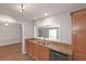 The eat-in kitchen has stainless steel appliances and granite countertops with view into the living room at 602 Abingdon Way, Atlanta, GA 30328