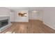 A bright living room featuring a fireplace, wood floors, and a pass-through to the kitchen at 602 Abingdon Way, Atlanta, GA 30328
