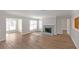 Spacious living room with wood floors, fireplace, and large windows at 602 Abingdon Way, Atlanta, GA 30328