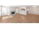 A bright living room featuring a fireplace, wood floors, and a pass-through to the kitchen at 602 Abingdon Way, Atlanta, GA 30328