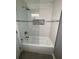Modern bathroom with white subway tile, glass shower, and tub at 2747 Santa Barbara Nw Dr, Atlanta, GA 30318
