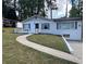 Inviting single-story house with a painted brick exterior, a pristine lawn, and an access walkway at 2747 Santa Barbara Nw Dr, Atlanta, GA 30318