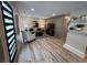 Stylish living room featuring a modern accent wall, chic decor, and plank flooring at 2747 Santa Barbara Nw Dr, Atlanta, GA 30318