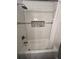 Modern tiled shower featuring sleek fixtures, a tiled niche, and a shower curtain at 2747 Santa Barbara Nw Dr, Atlanta, GA 30318