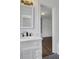 Bright bathroom with white vanity, black faucet and mirror, plus view of the wardrobe in an adjacent room at 8 Collier Nw Rd # B2, Atlanta, GA 30309