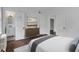 Primary bedroom showcasing hardwood floors, neutral paint, and ensuite bathroom at 8 Collier Nw Rd # B2, Atlanta, GA 30309