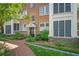 Brick condo building featuring well-maintained landscaping and inviting entrance with a brick walkway and manicured garden at 8 Collier Nw Rd # B2, Atlanta, GA 30309