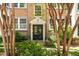 Charming exterior featuring a well-manicured front yard and an inviting entrance framed by mature trees and lush greenery at 8 Collier Nw Rd # B2, Atlanta, GA 30309