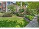 Charming brick building featuring lush landscaping and mature trees for a beautiful curb appeal at 8 Collier Nw Rd # B2, Atlanta, GA 30309