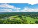 Overhead view of golf course, club house, and tennis courts surrounded by lush, mature trees at 8 Collier Nw Rd # B2, Atlanta, GA 30309