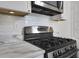 Kitchen with gas range, marble countertop, stainless steel appliances, and subway tile backsplash at 8 Collier Nw Rd # B2, Atlanta, GA 30309