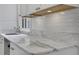 Marble countertops and white herringbone backsplash in a naturally-lit, modern kitchen at 8 Collier Nw Rd # B2, Atlanta, GA 30309