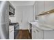 Modern kitchen with white cabinets, stainless steel appliances, and marble countertops at 8 Collier Nw Rd # B2, Atlanta, GA 30309