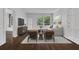 Bright living room with hardwood floors, modern furniture, and large windows that let in natural light overlooking the landscape at 8 Collier Nw Rd # B2, Atlanta, GA 30309