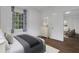 Well-appointed main bedroom with a large window, cozy bed, and stylish cabinet for ample storage at 8 Collier Nw Rd # B2, Atlanta, GA 30309