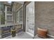 Cozy screened patio with a brick wall, outdoor seating, and a view of the building's exterior and yard at 8 Collier Nw Rd # B2, Atlanta, GA 30309
