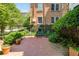Secluded brick patio with bistro set nestled amongst lush greenery and climbing vines on brick building facade at 8 Collier Nw Rd # B2, Atlanta, GA 30309