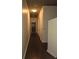 Long hallway with dark hard wood floors and off white walls at 855 Peachtree Ne St # 1912, Atlanta, GA 30308