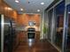 Modern kitchen with stainless steel appliances, wood cabinets, and a city skyline view at 855 Peachtree Ne St # 1912, Atlanta, GA 30308
