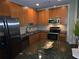 Contemporary kitchen features stainless steel appliances and a spacious granite countertop at 855 Peachtree Ne St # 1912, Atlanta, GA 30308