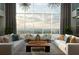 Bright living room with floor-to-ceiling windows and comfortable seating at 855 Peachtree Ne St # 1912, Atlanta, GA 30308