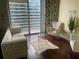 Bright living room featuring a plush sofa, chairs, and stunning city views from a private balcony at 855 Peachtree Ne St # 1912, Atlanta, GA 30308