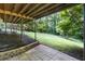 Backyard featuring a stone patio and expansive yard with mature trees and a playground at 13 Sherman Nw Ln, Cartersville, GA 30121