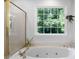 This bathroom features a soaking tub with jets and large window showcasing the greenery outside at 13 Sherman Nw Ln, Cartersville, GA 30121