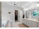 Bright bathroom featuring a garden tub, step-in shower, double vanity, and walk-in closet at 13 Sherman Nw Ln, Cartersville, GA 30121