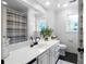 Bright bathroom features a large mirror, white vanity, and a shower with a striped curtain at 13 Sherman Nw Ln, Cartersville, GA 30121
