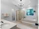 Bright bathroom featuring a garden tub, step-in shower, double vanity, and large window at 13 Sherman Nw Ln, Cartersville, GA 30121