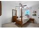 Well-lit bedroom featuring a wooden bed frame, ceiling fan, and natural light from the window at 13 Sherman Nw Ln, Cartersville, GA 30121
