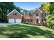 Elegant brick home with a well-manicured lawn, lush landscaping, and attached two car garage at 13 Sherman Nw Ln, Cartersville, GA 30121