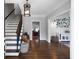 Bright foyer showcasing hardwood floors, elegant lighting, and charming decor, plus staircase and alphabet art at 13 Sherman Nw Ln, Cartersville, GA 30121