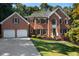 Beautiful two-story brick home with a well-manicured lawn and two-car garage at 13 Sherman Nw Ln, Cartersville, GA 30121