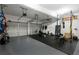 Spacious two car garage featuring home gym with weightlifting and exercise equipment at 13 Sherman Nw Ln, Cartersville, GA 30121