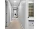Long hallway with neutral walls, multiple doors, and overhead lighting leading to other rooms at 13 Sherman Nw Ln, Cartersville, GA 30121