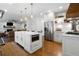 Spacious kitchen featuring a central island, stainless steel appliances, and hardwood floors at 13 Sherman Nw Ln, Cartersville, GA 30121