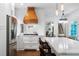 A chef's kitchen with a wooden range hood, stainless steel appliances, and a large central island at 13 Sherman Nw Ln, Cartersville, GA 30121