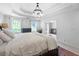 Light-filled main bedroom featuring a tray ceiling, dual windows, and neutral decor at 13 Sherman Nw Ln, Cartersville, GA 30121