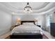 Luxurious main bedroom features a trey ceiling with modern light fixture and plush bedding at 13 Sherman Nw Ln, Cartersville, GA 30121