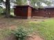 Backyard exterior showing siding, trees, and partial view of the home at 144 Flat Rock Rd, Oxford, GA 30054