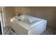A standalone white tub sits on linoleum flooring in this bathroom at 144 Flat Rock Rd, Oxford, GA 30054