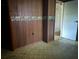 A bedroom featuring wood paneling, wallpaper trim, and patterned linoleum flooring at 144 Flat Rock Rd, Oxford, GA 30054