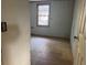 Cozy bedroom featuring paneled walls and a large window offering natural light at 144 Flat Rock Rd, Oxford, GA 30054