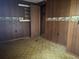 Bedroom featuring wood paneled walls, patterned flooring, and closet at 144 Flat Rock Rd, Oxford, GA 30054