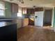 Spacious kitchen features wood cabinets, laminate countertops, and a view to another room at 144 Flat Rock Rd, Oxford, GA 30054