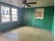 View of living room with two windows, ceiling fan, and paneled walls, ready for customization at 144 Flat Rock Rd, Oxford, GA 30054